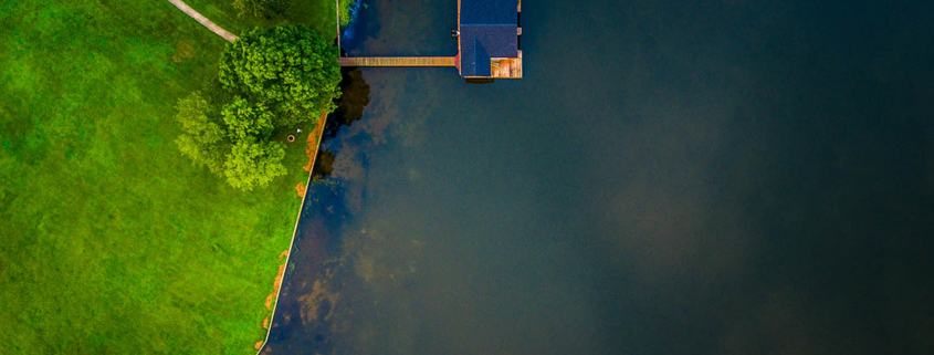 aerial shot of a house on a lake